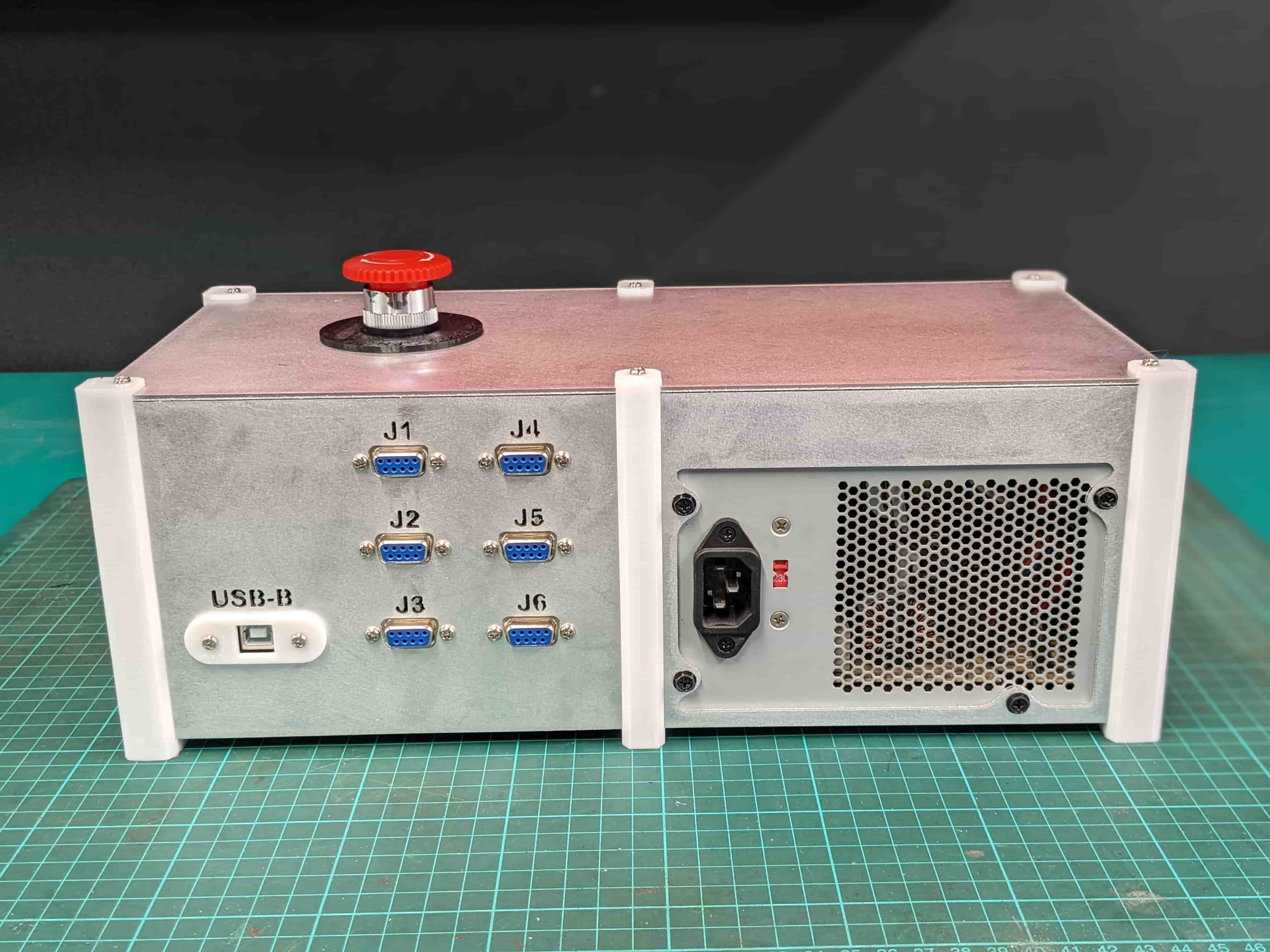 Rear panel of the control enclosure with power entry, cooling fan and labelled motor connectors