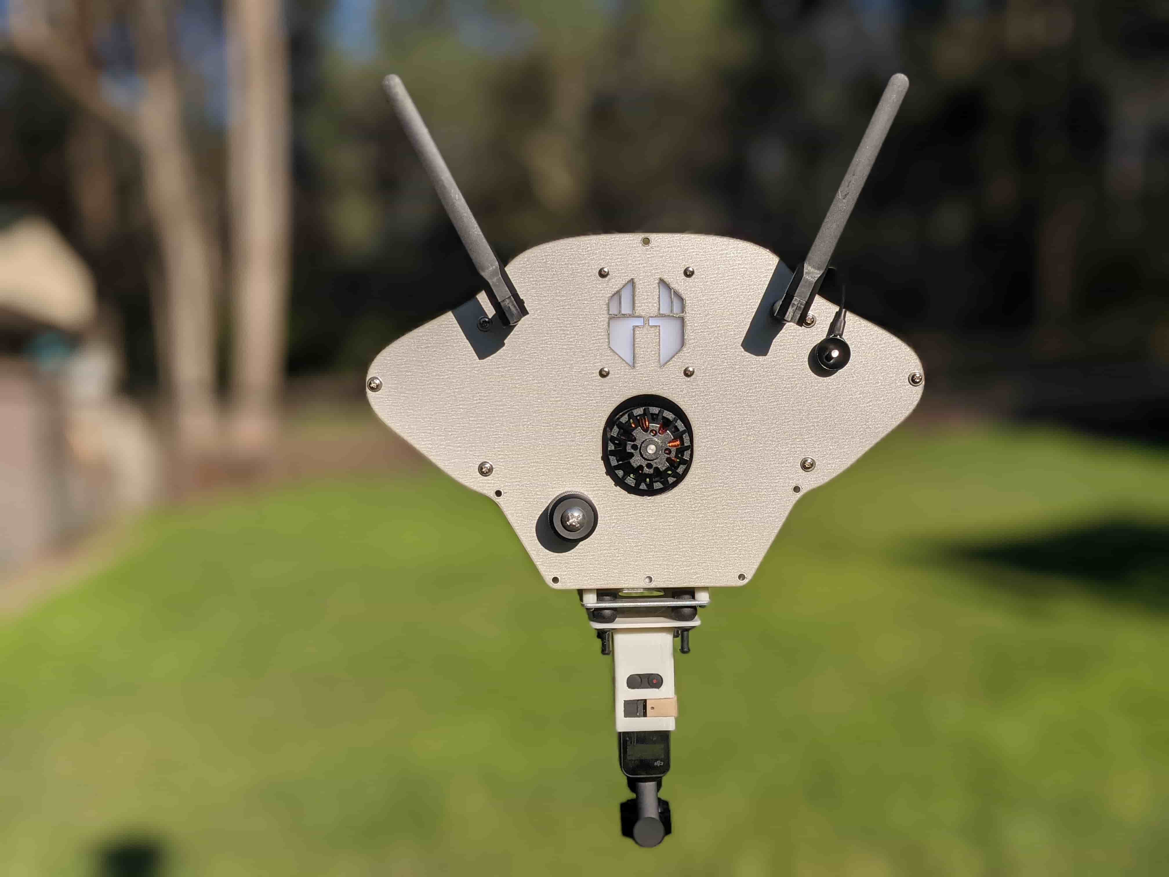Complete cable camera car outdoors with a camera suspended beneath the chassis