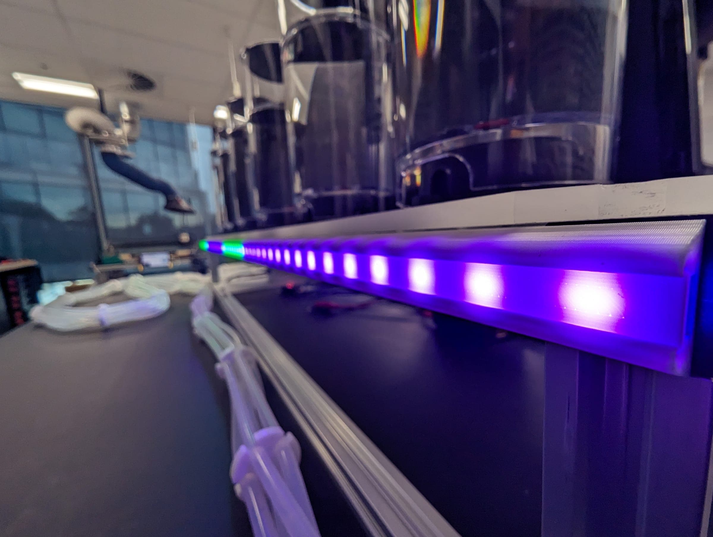 Close-up of the gustometer status light bar illuminated beneath the fluid reservoirs