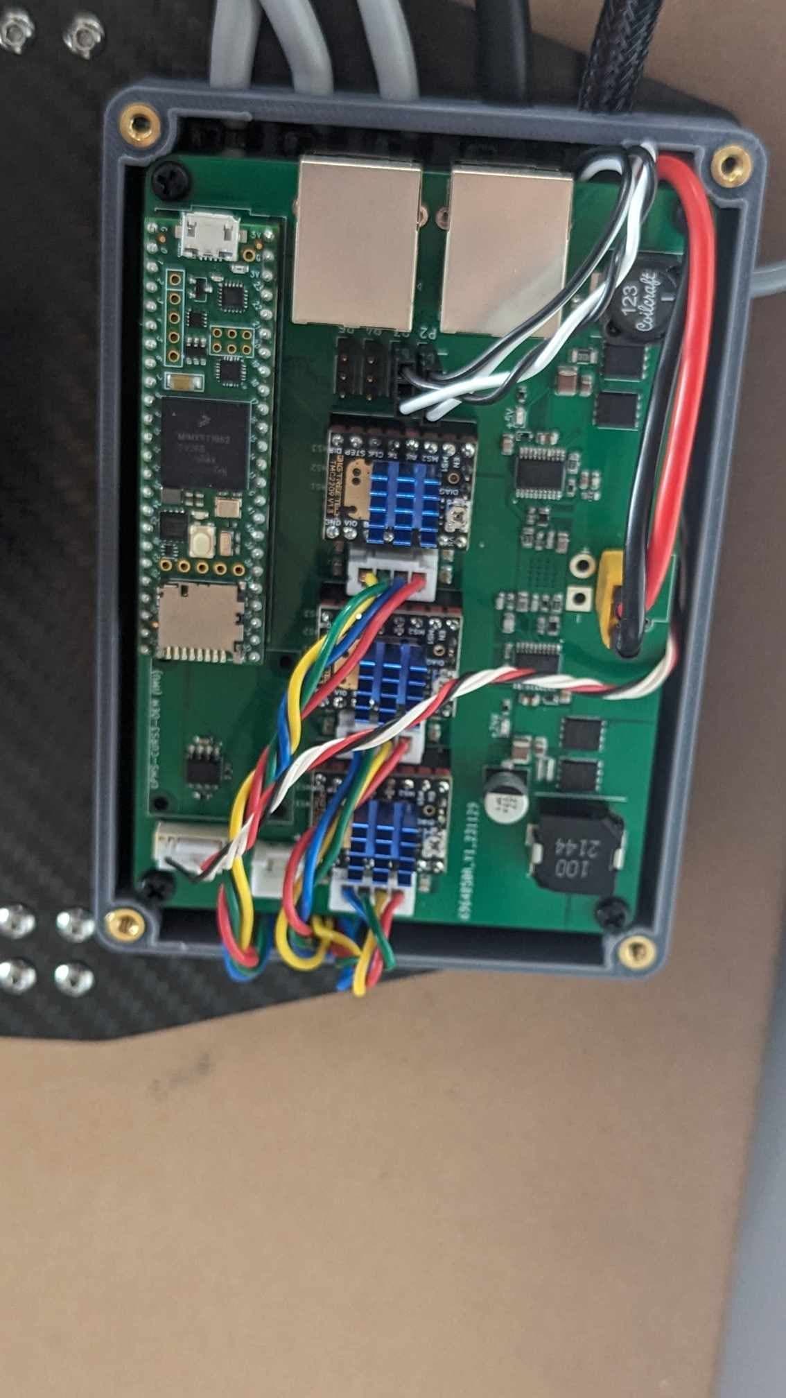 Custom carrier board and motor drivers wired inside the payload controller enclosure